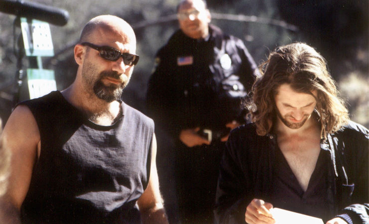 Set still photograph of Kevin Gage and Stephen Wozniak between takes on location in the Angeles National Forest for the true crime feature film CHAOS.
