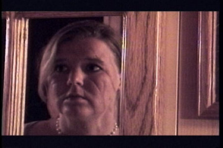 Camille (Michelle Gay) in mirror.