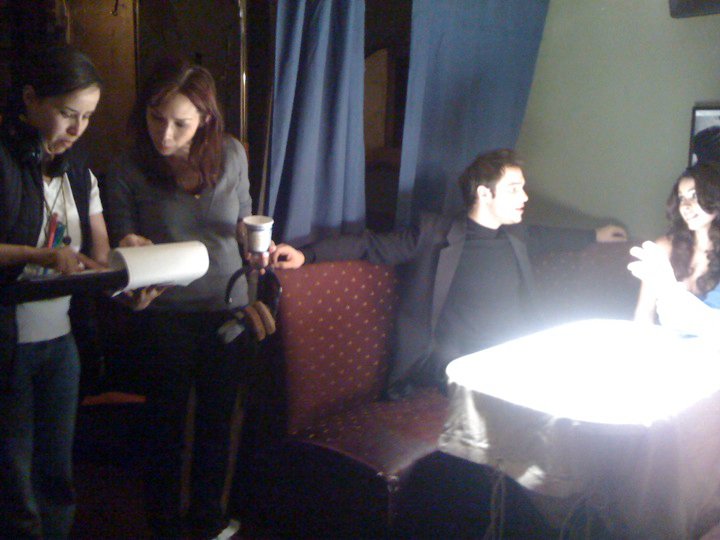 Looking over script with script supervisor Amina Ouchater before directing actors Taso Mikroulis and Jessica Caban.