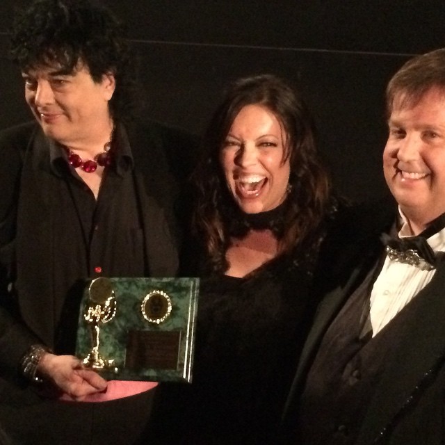 Michelle Tomlinson receives a Golden Halo Award from Randal Malone and Tom Tangen at the 79th Golden Halo Award Ceremony for the Southern California Motion Picture Council.