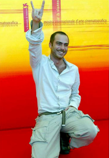 VENICE, ITALY: Greek actor Thanos Samaras gestures as he poses during a photo call at Venice Lido 2 September 2004. Samaras is in Venice to present in competition Nikos Panayatopoulos' movie 'Delivery'. The 61st Venice International Film Festival runs until 11 September with 21 films in competition for the Golden Lion main prize.