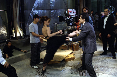 JENNIFER LOVE HEWITT (center left) gets some help from JACKIE CHAN (center right) on one of her high-kicking moves, as director KEVIN DONOVAN (rear center) and star RITCHIE COSTER (rear right) look on