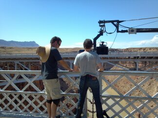 Actor Mark Kassen prepares to stand on the railing of the Navajo Bridge in Arizona.. Stunt Rigger was Rich Hopkins