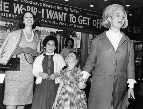 Sybil Burton and children Kate (left) and Jessica, beam as they leave matinee performance of the musical, 