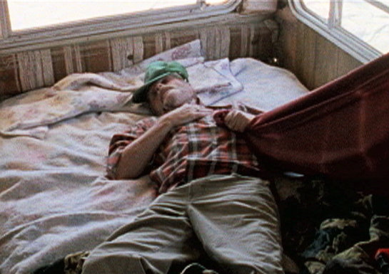 John (Maury Brooks) passed out in his Trailer.