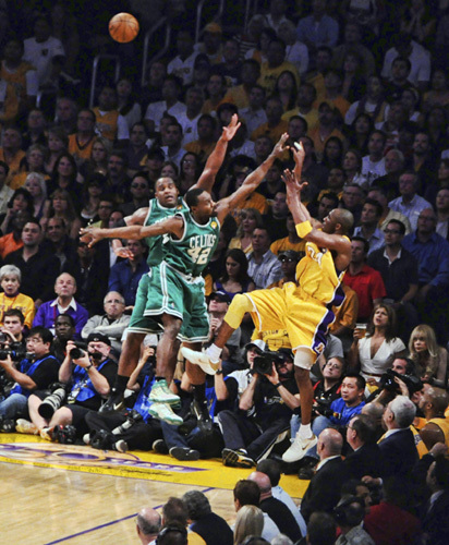 Kobe Bryant of the Los Angeles Lakers doing a turnaround jumper over Glen Davis and Tony Allen of the Boston Celtics at game 7 of the NBA finals