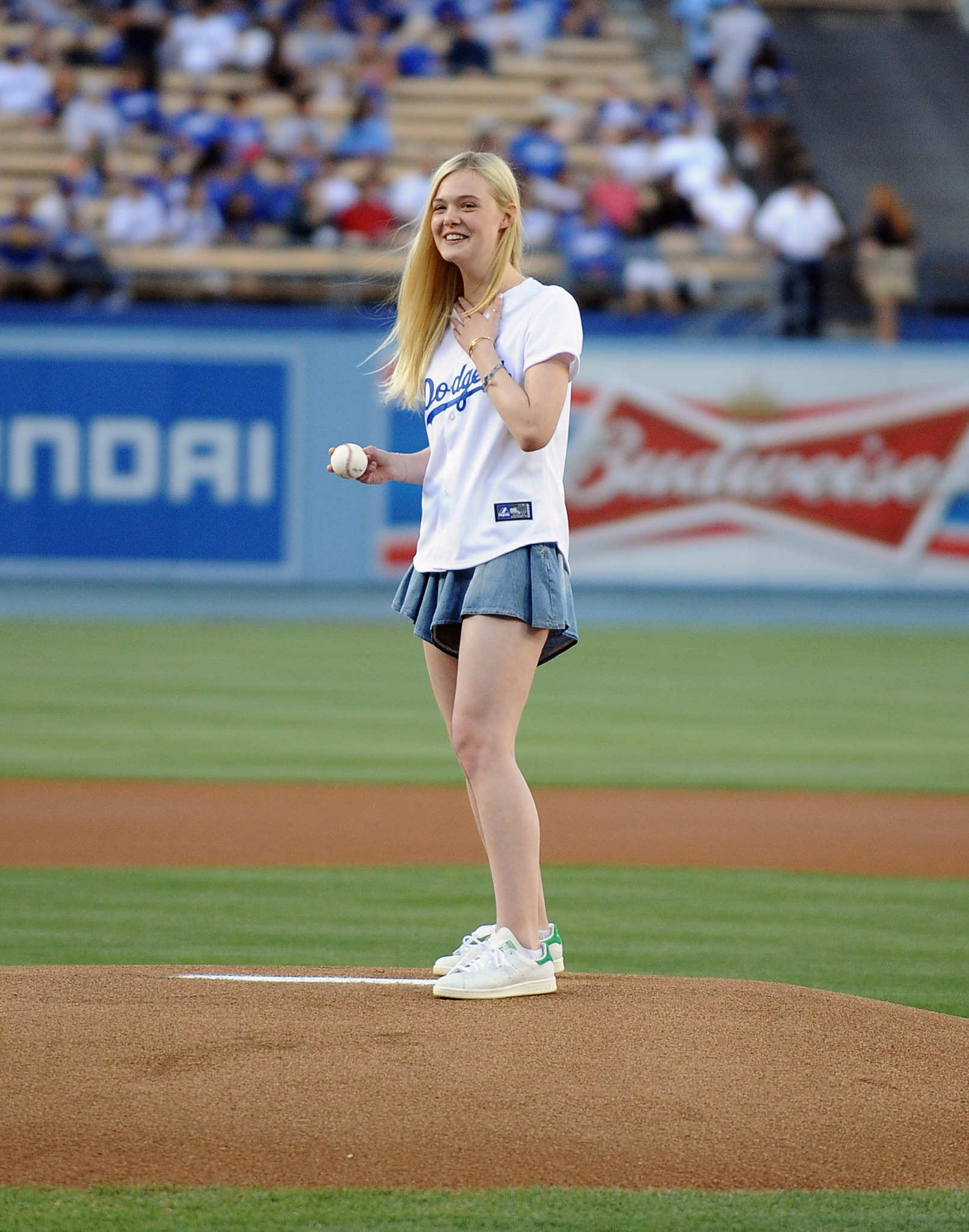 Actress Elle Fanning throws out the ceremonial first pitch before the game between the Chicago White Sox and Los Angeles Dodgers at Dodger Stadium on June 4, 2014 in Los Angeles, California.