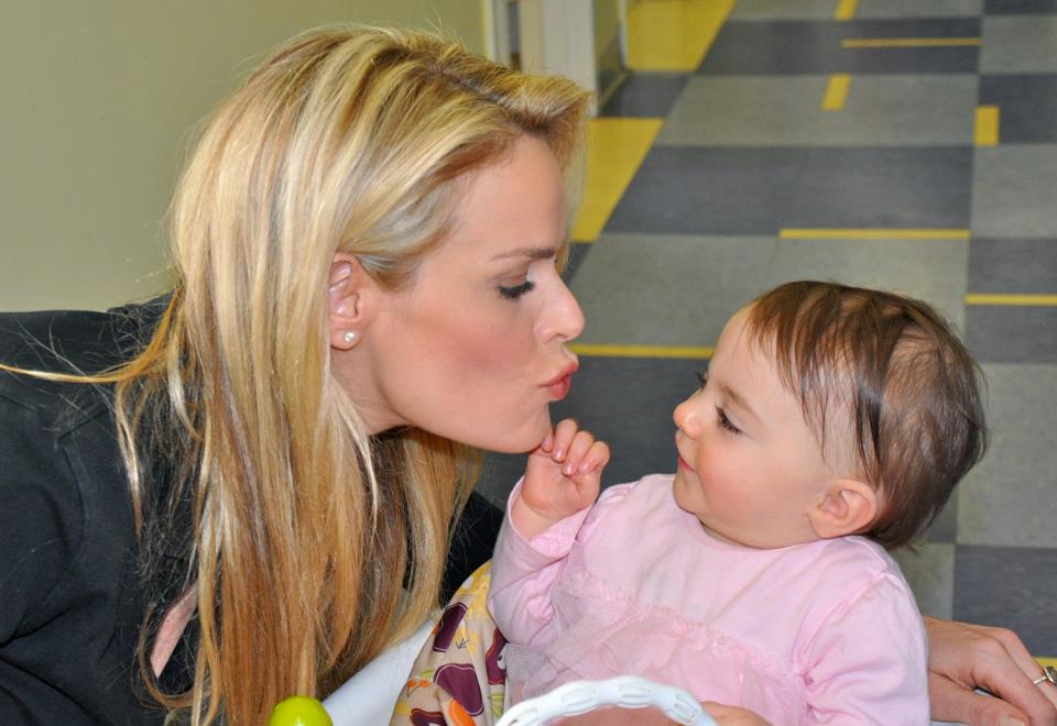 Heidi Albertsen, goodwill ambassador of the Lower Eastside Service Center, visits with an infant at Su Casa, a residential treatment facility in New York City that benefits opiate-addicted pregnant women and children, 2012.