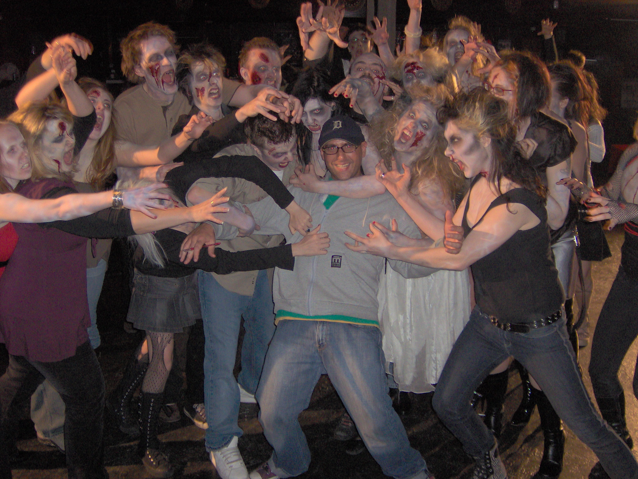 Director David Langlois surrounded by zombies on the set of Jet Set Satellite's 