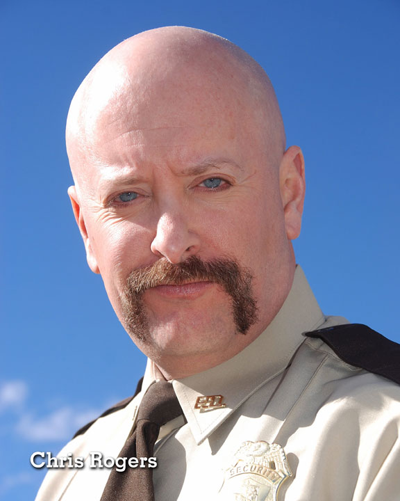 Chris Rogers State Trooper in front of blue sky background.