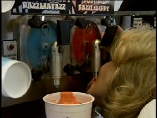 Suzanne Sole sucking a slurpee from the machine as White Trash Mom in What News? for TBS