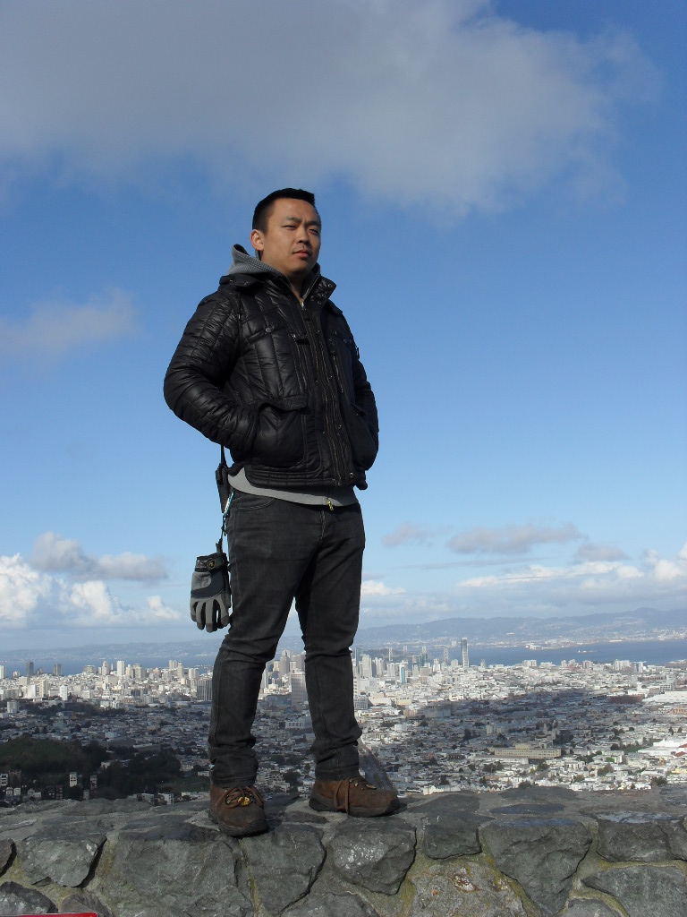 Nu Zhang standing on top of the world; San Francisco CA.