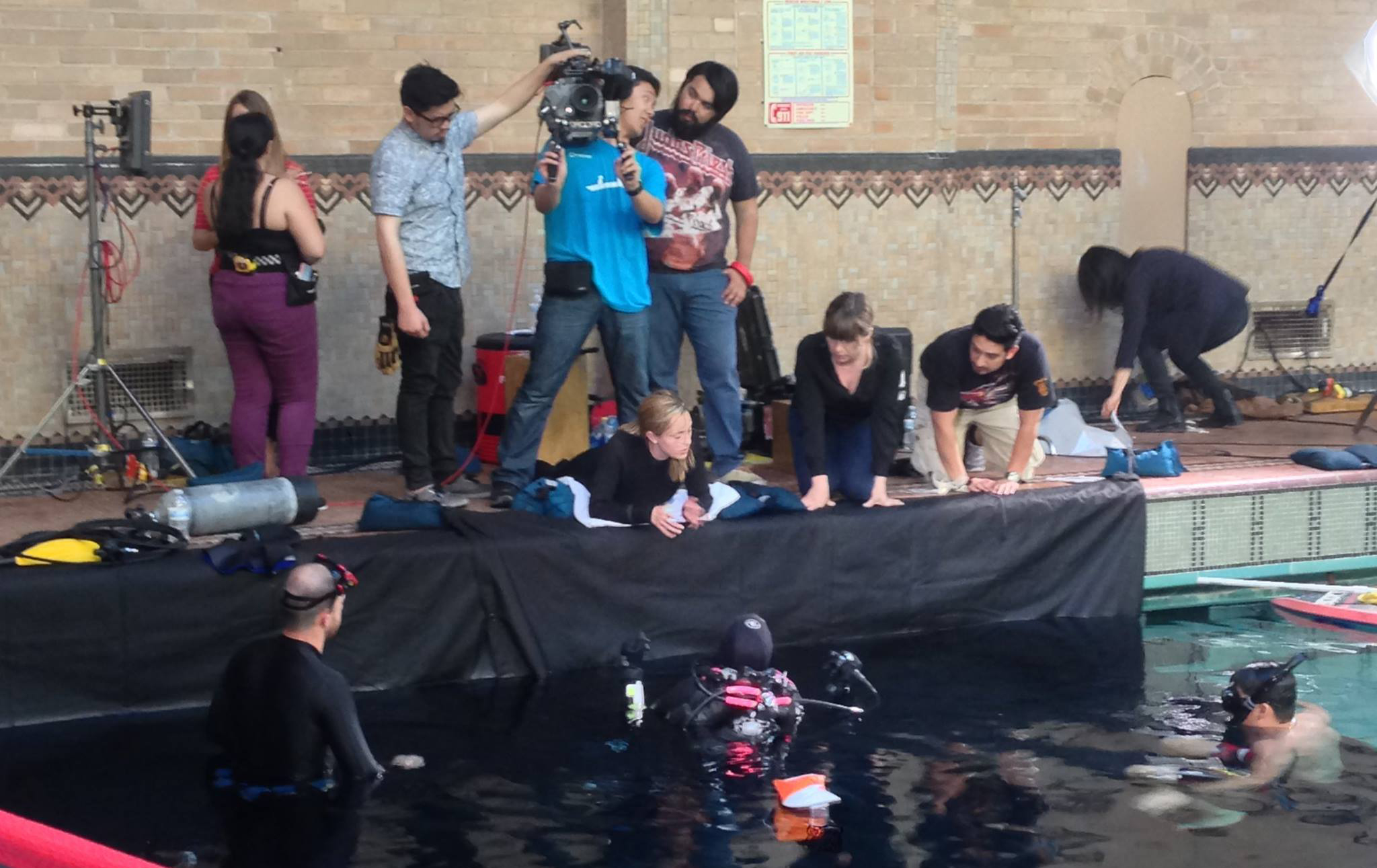 Amanda Tasse (center right) directs stunt double Andrea Kemp (center) and actor Vanessa Patel (center for a pool VFX action scene in MIRA.