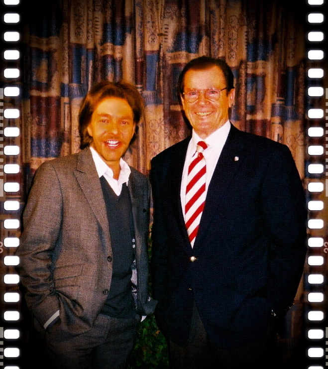 David Giammarco and Sir Roger Moore, sharing a laugh in London, England.