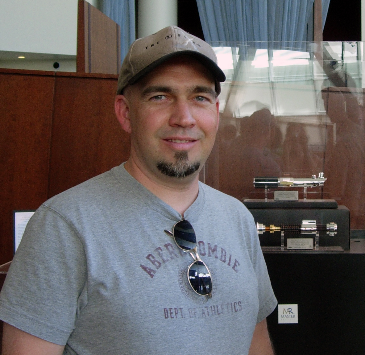 Jon Teboe standing in front of light saber props at a special screening of 