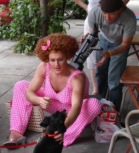 Jeffery Roberson as Varla Jean Merman (feeding a biscuit to a puppy) and Vidkid Timo (holding camera).