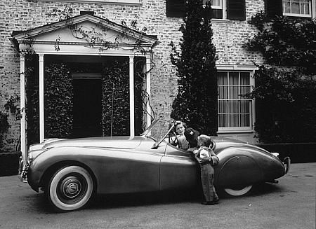 Humphrey Bogart, Lauren Bacall and son Stephen at home in Beverly Hills with his XK 120 Jaguar
