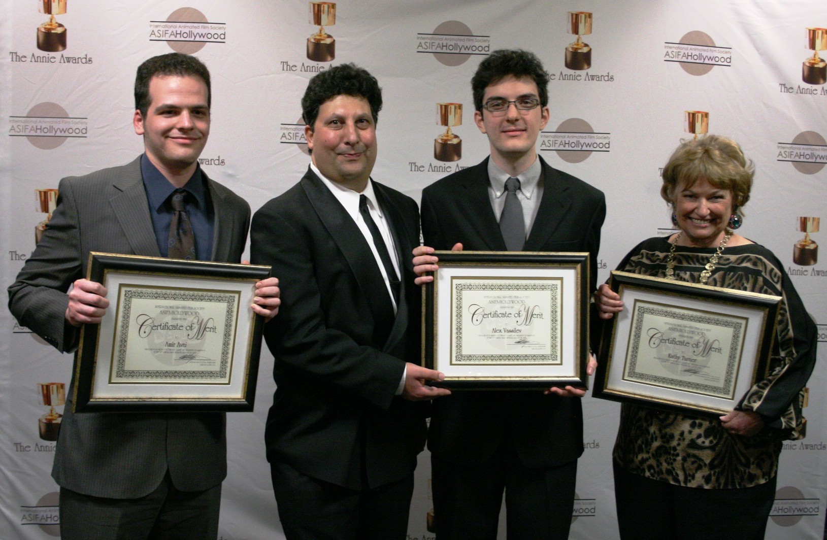 ASIFA president Antran Manoogian congratulates this year's certificate of merit winners, Amir Avni, Alex Vassilev, and Kathy Turner