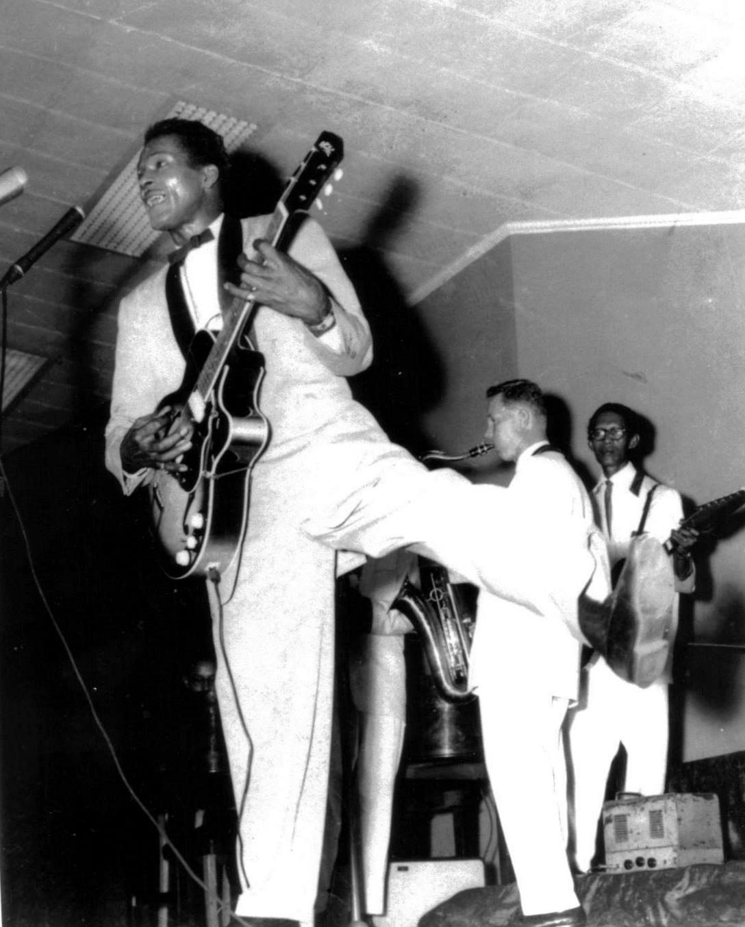 Chuck Berry in full flight, with Johnny Greenan on tenor sax and Lou Nanlohy on guitar supporting in the back ground.@ Melbourne Festival Hall in 1958