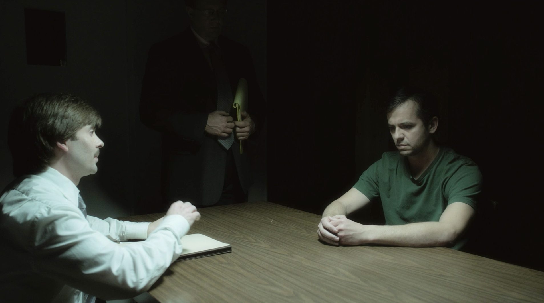 Todd Jenkins as Bruce Chesser getting interrogated.