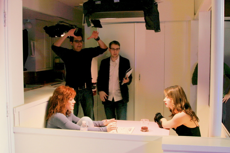 Casey (center) on set Directing a music video with Director of Photography, Art Santamaria (upper left), Actress, Elisa Donovan (left), and Singer, Lisa Donnelly (right).