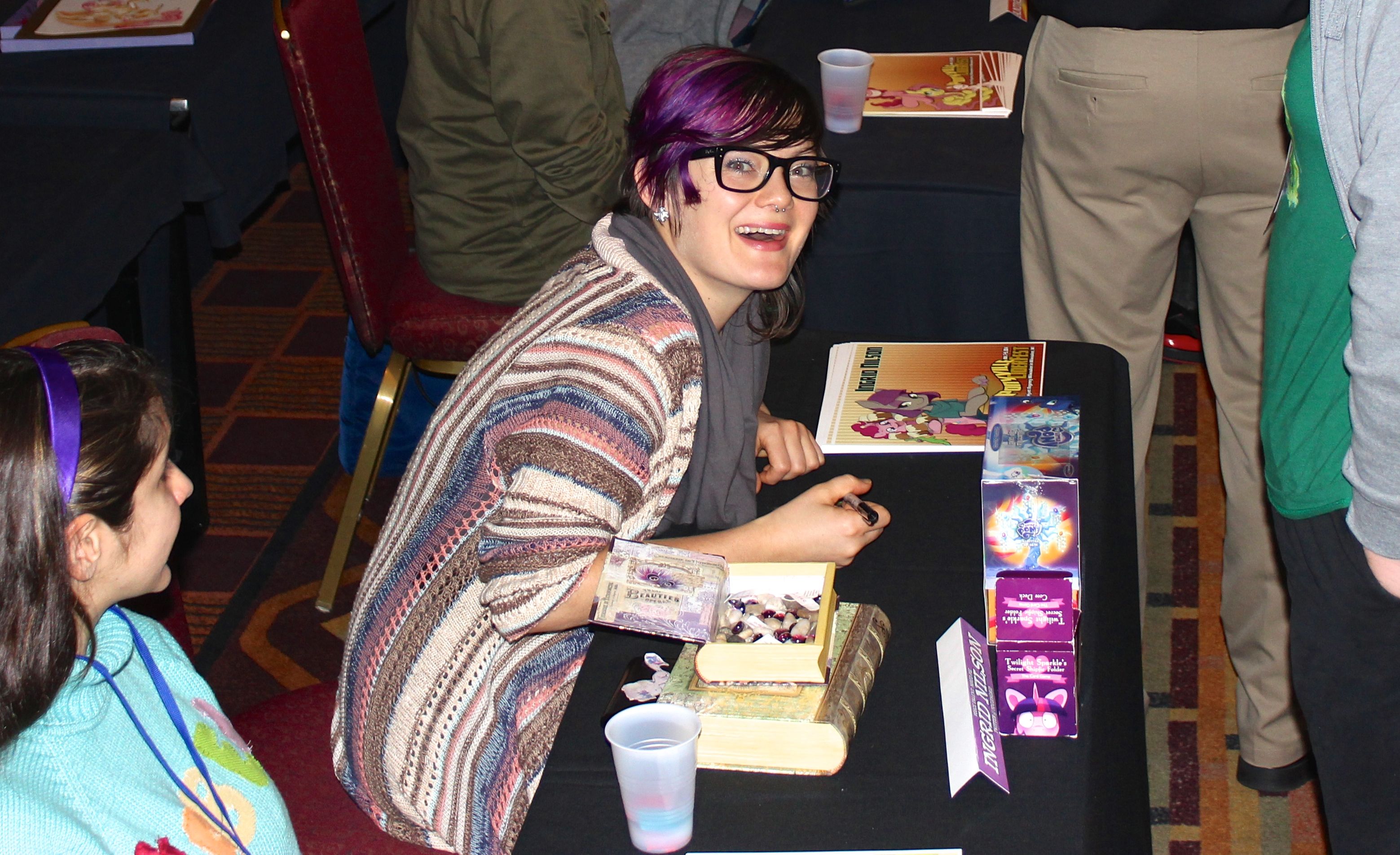 Ingrid at Ponyville Ciderfest signing autographs.