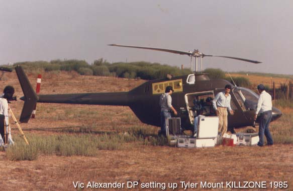 Vic Alexander, DP, setting up Tyler Mount on helicopter during the filmming of KILLZONE, 1985.