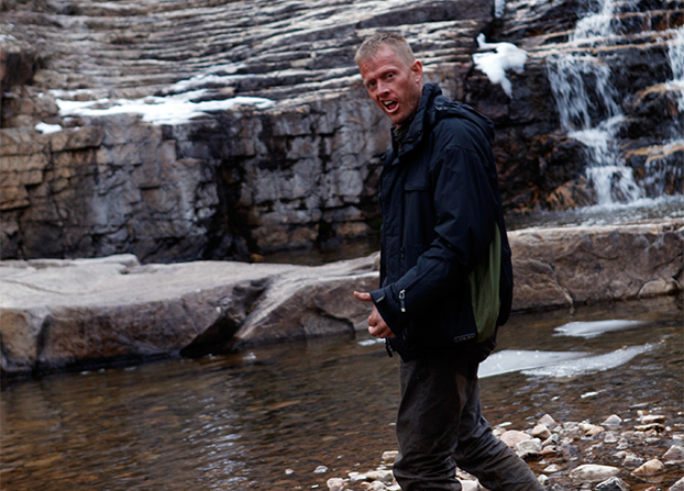 Still of Trevor Snarr taking a break between set-ups during the filming of 