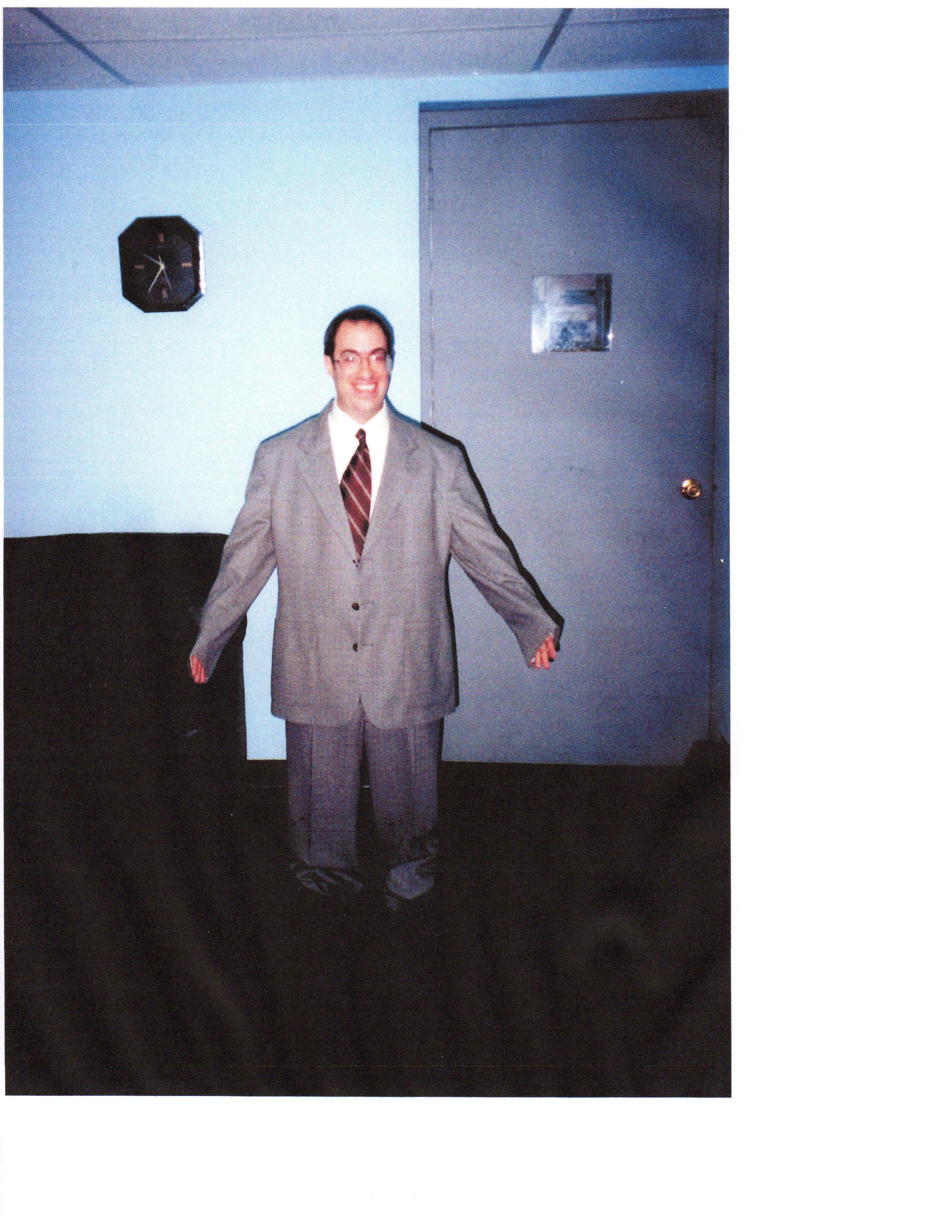 Jeff Eigen as a short guy in a big suit on the set of an AT&T commercial