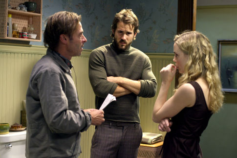 Director ANDREW DOUGLAS discusses a scene with RYAN REYNOLDS and MELISSA GEORGE on the set of THE AMITYVILLE HORROR.