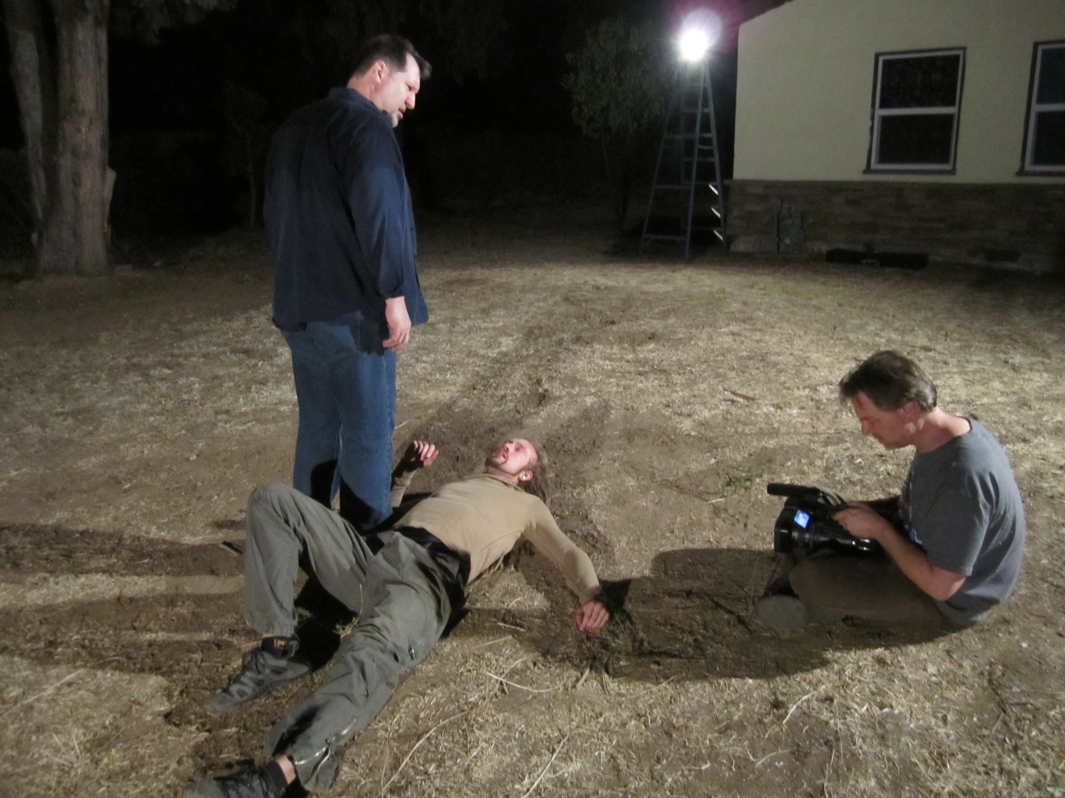 Actor/Director Brian Reed Garvin in the role of Archer Stone, prepares to stomp Actor Azmyth Kaminski as Cameraman Marc Elmer pulls focus for the feature film 