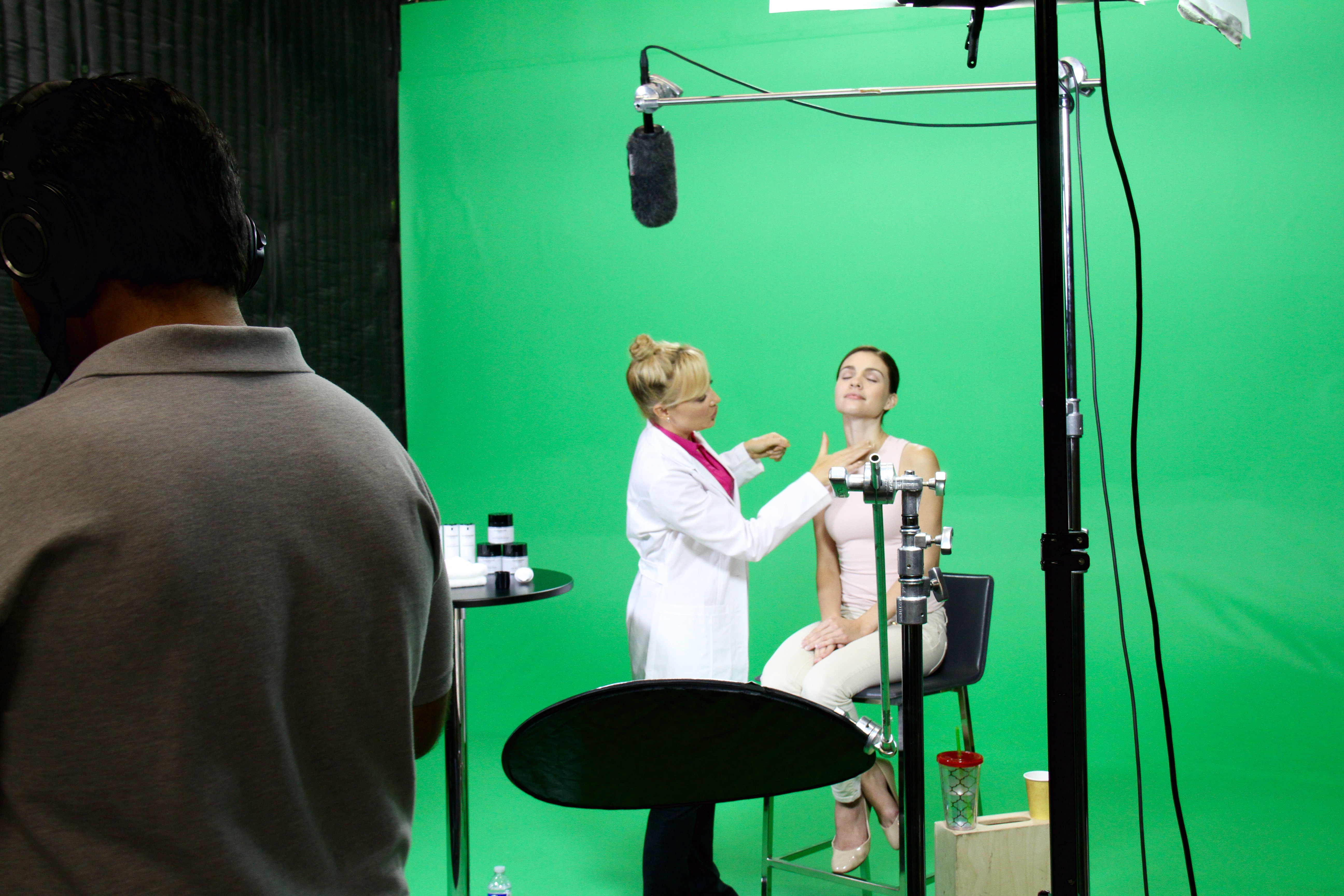 Host Stacey Hayes demonstrating proper technique on set of CHERINE SKIN CARE commercial and instructional videos