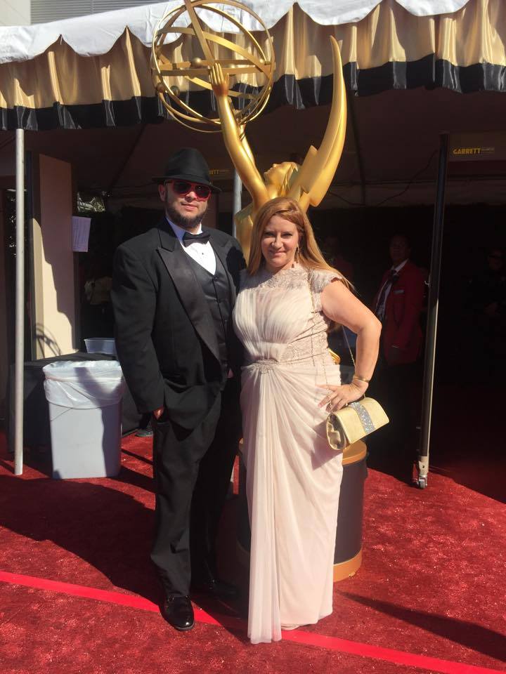 Writer Chris Molina and Producer Peggy Lane arrive at the 2015 Emmys.