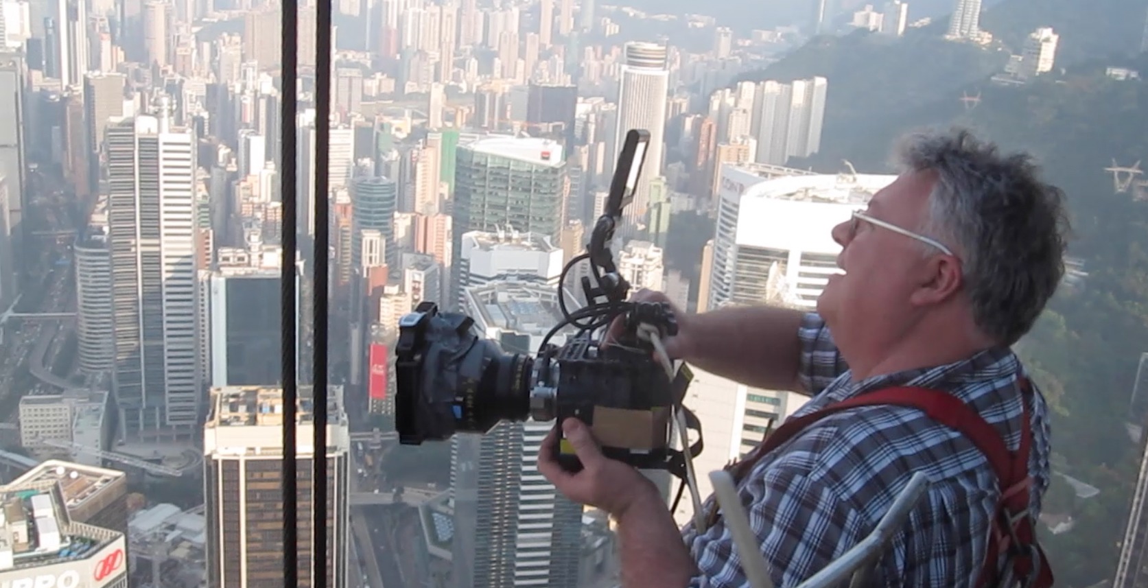 shooting flying robots from Bank of China's window cleaning bucket, 69 floors up. RED Epic, 25mm Anamorphic lens