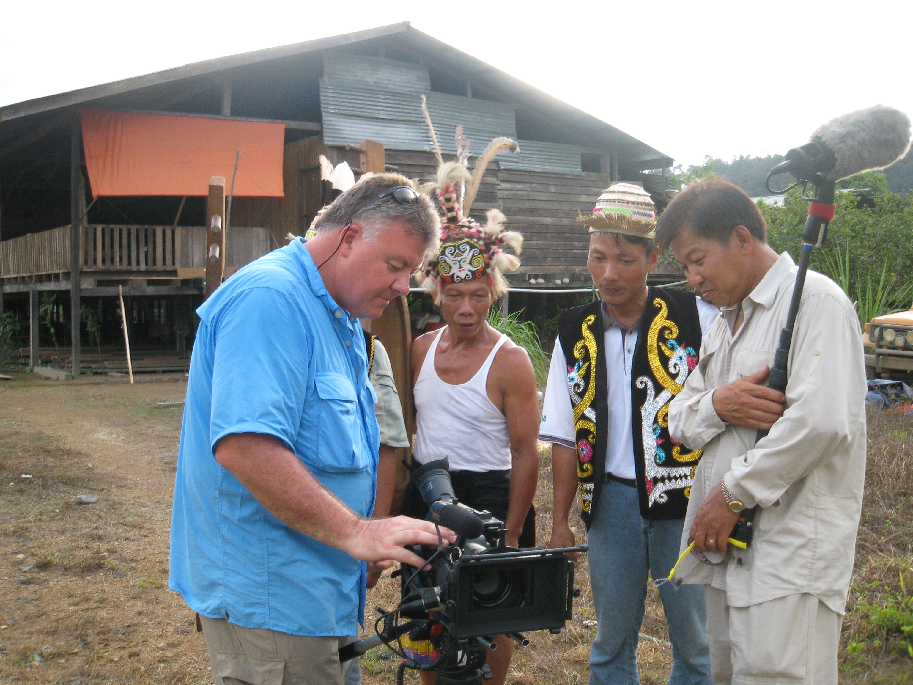 replaying footage to the villagers in Sarawak jungle, Malaysia