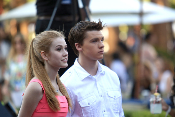 Joel Courtney (R) and Katherine McNamara attend Variety's Power of Youth presented by Hasbro and GenerationOn at Universal Studios Backlot on July 27, 2013 in Universal City, California.
