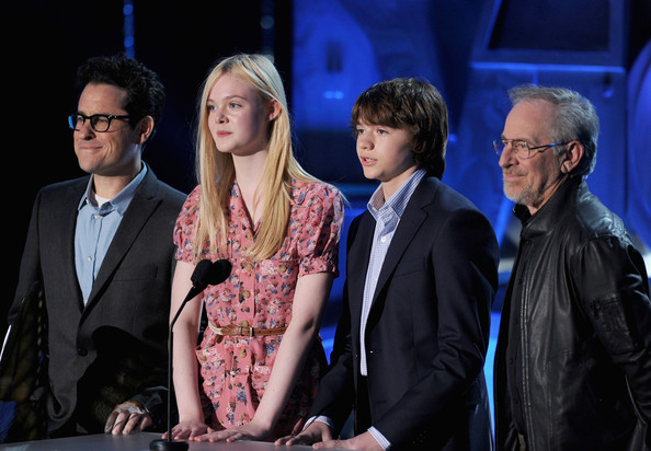 J.J. Abrams, Elle Fanning, Joel Courtney, and Steven Spielberg speak onstage during the 2011 MTV Movie Awards at Universal Studios' Gibson Amphitheatre on June 5, 2011 in Universal City, California.