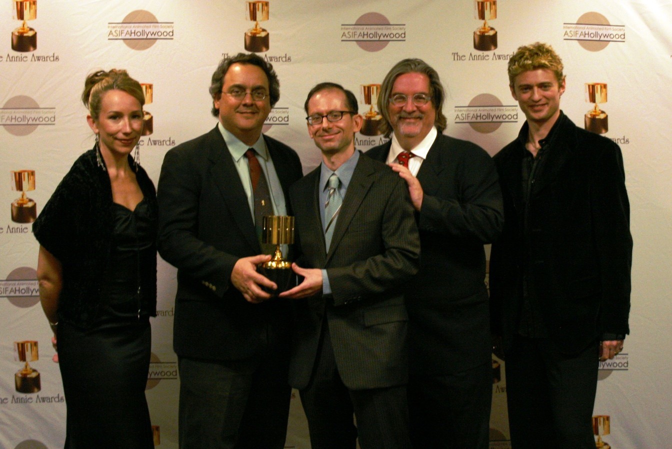 Presenters Jennifer Taylor Lawrence and Crispin Freeman flank Best Home Entertainment Production winners Peter Avanzino, David X. Cohen, Matt Groening