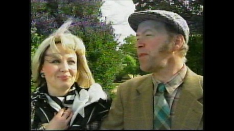 Still of Gwenfair Vaughan as series regular Megan in the second season of the Hafod Haidd/Barley Farm comedy series, with Dyfan Roberts.