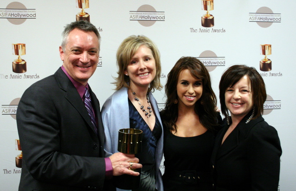 Best Animated Television Production (Prep & Landing) winners Kevin Deters, Stevie Wermers-Skelton, and Dorothy McKim with presenter Lacey Chabert