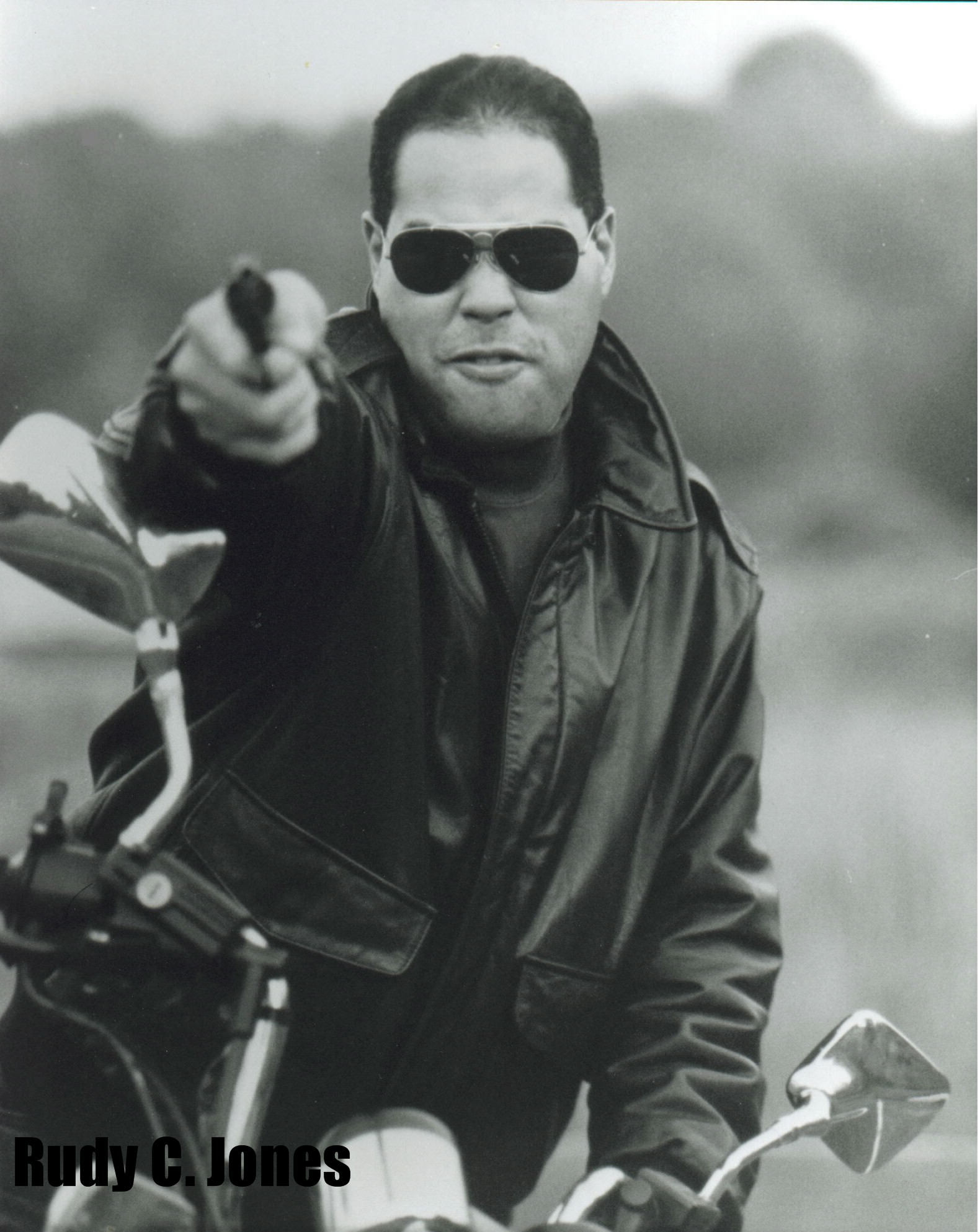 Rudy C. Jones w/gun on a motorcycle headshot(8x10)for NY Undercover FOX TV