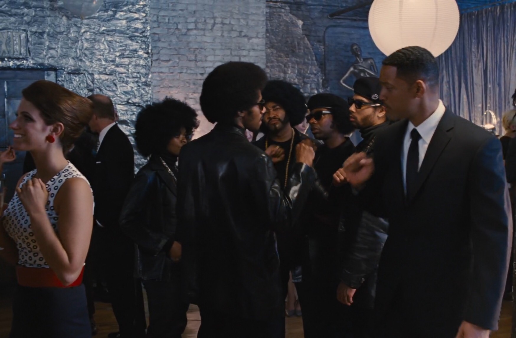 Huey Newton (Dennis Jay Funny) and the Black Panthers give Agent J a pound, at Andy Warhol's party back in time 1969. -'Men In Black 3' IMAX film