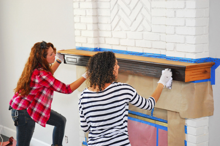 Bama & Deborah giving their fireplace mantel a fresh coat of walnut stain on Fyi Networks 