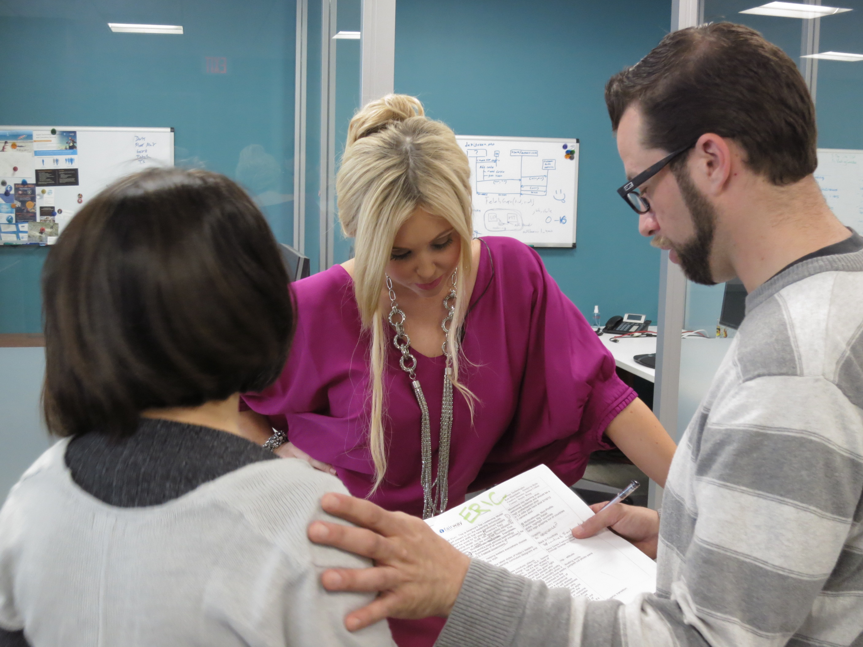 Producer Wendy Wong, talent and Director Eric Staley review the script.