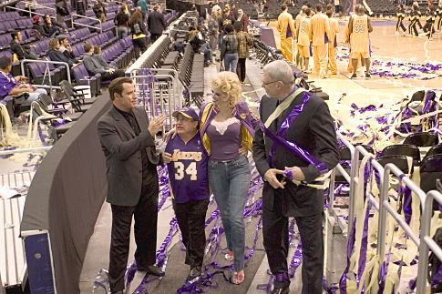 Chili (JOHN TRAVOLTA) talks with Martin Weir (DANNY DeVITO), ANNA NICOLE SMITH, and PHIL JACKSON after a Lakers game in MGM Pictures' comedy BE COOL.