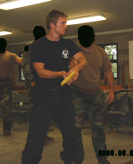 Jared Day instructing United States Special Operations soldiers in a gun disarming technique.