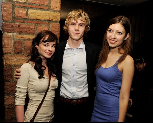 Actress Shelby Young poses with co-star Evan Peters and actress Ashley Rickards at the premiere of 