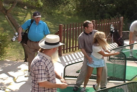 Cindy Pucci swings on the driving range while other golfers stare in disbelief during the filming of 