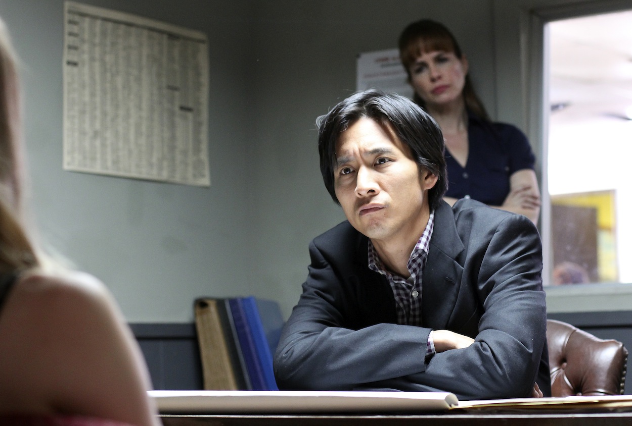 Roy Vongtama as Detective Lee in Death Clique (2014). Stephanie Erb as Detective Gaines (background).