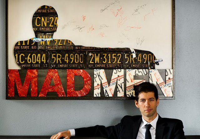 Foster poses with a piece of his art signed by the cast and creator of Mad Men.